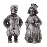 A pair of silver pepperettes modelled as a boy and girl