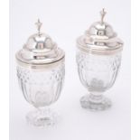 A pair of George III glass mustard jars with silver covers by Charles Chesterman II