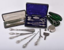 A cased Edwardian silver mounted seven piece manicure set by Robert Pringle & Sons