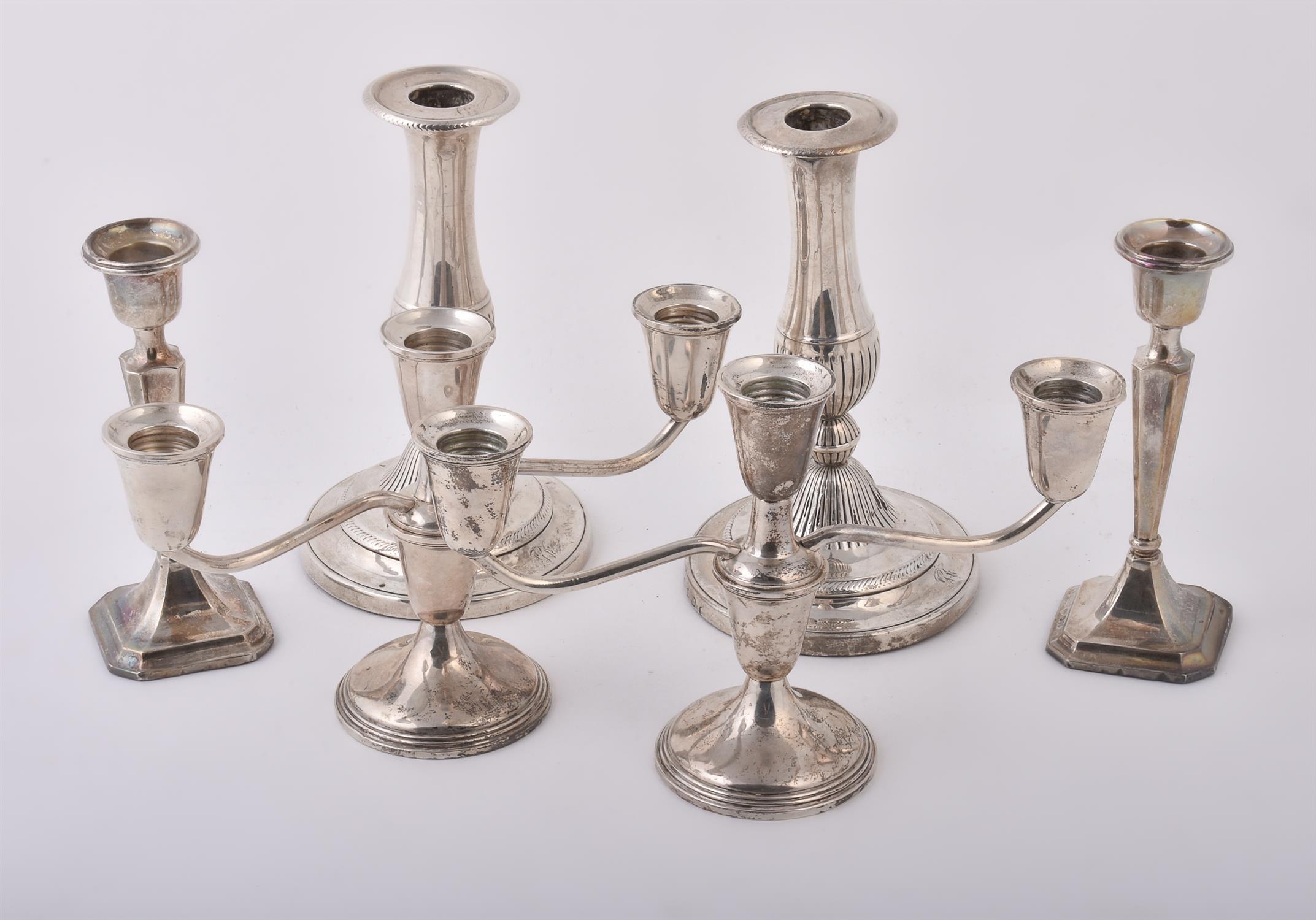 A pair of silver coloured twin branch candelabra