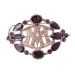 An early 20th century diamond garnet brooch