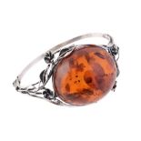 A clarified amber and silver coloured hinged bangle