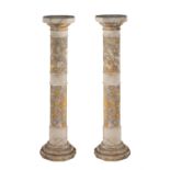 A pair of sectional veined alabaster columnar pedestals