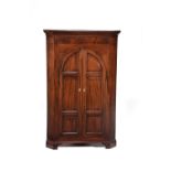 A mahogany standing corner cupboard