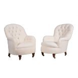 A pair of Victorian walnut and button upholstered armchairs