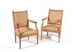 A pair of beech and upholstered armchairs