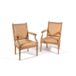 A pair of beech and upholstered armchairs