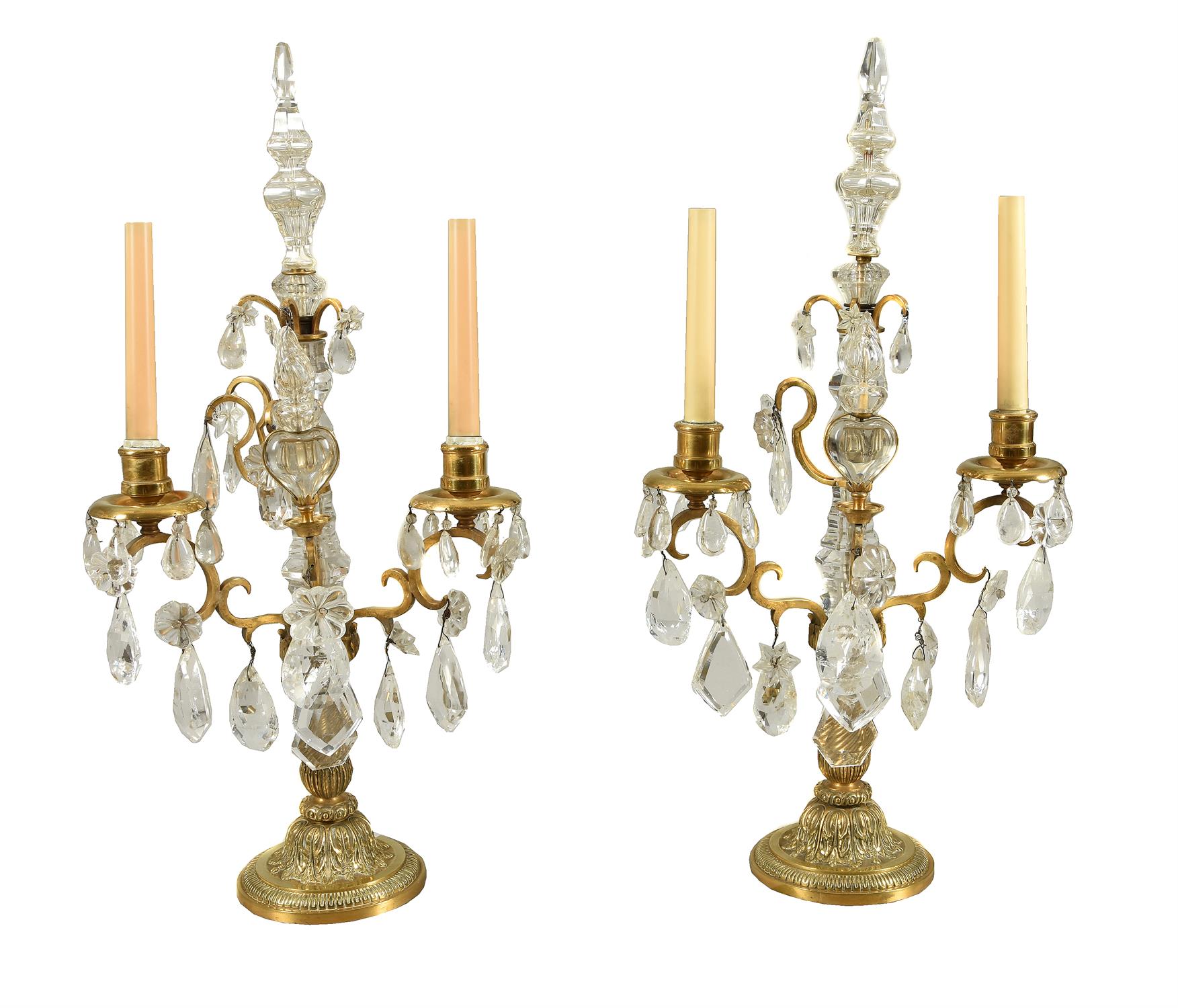 A pair of cut glass and rock crystal mounted gilt metal twin light candelabra in 18th century taste