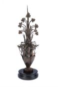 A wrought and sheet iron roof finial modelled as a flowering vase