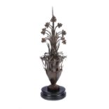 A wrought and sheet iron roof finial modelled as a flowering vase