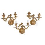 A set of four French gilt metal twin branch wall lights