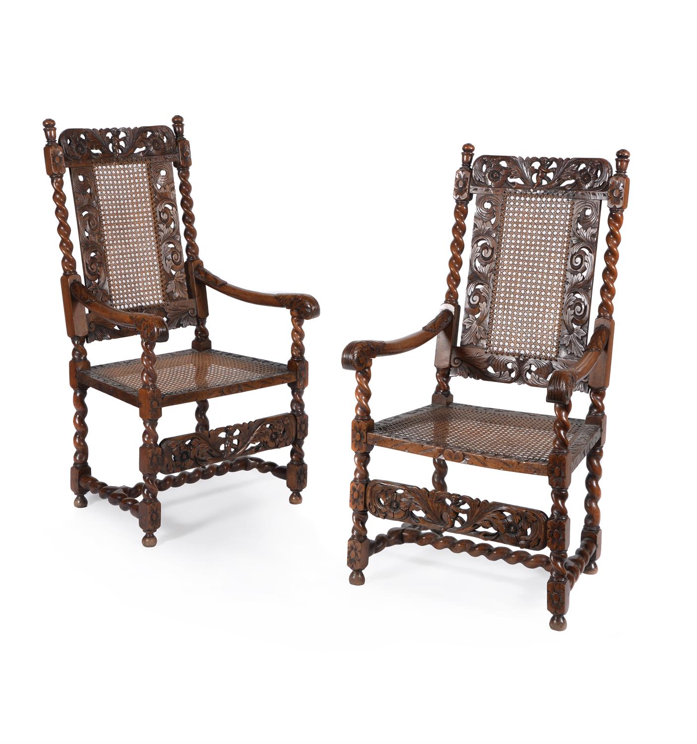 A pair of Charles II caved walnut armchairs