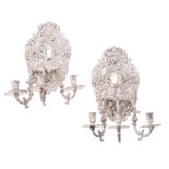 A pair of silvered metal three light sconces in William and Mary taste