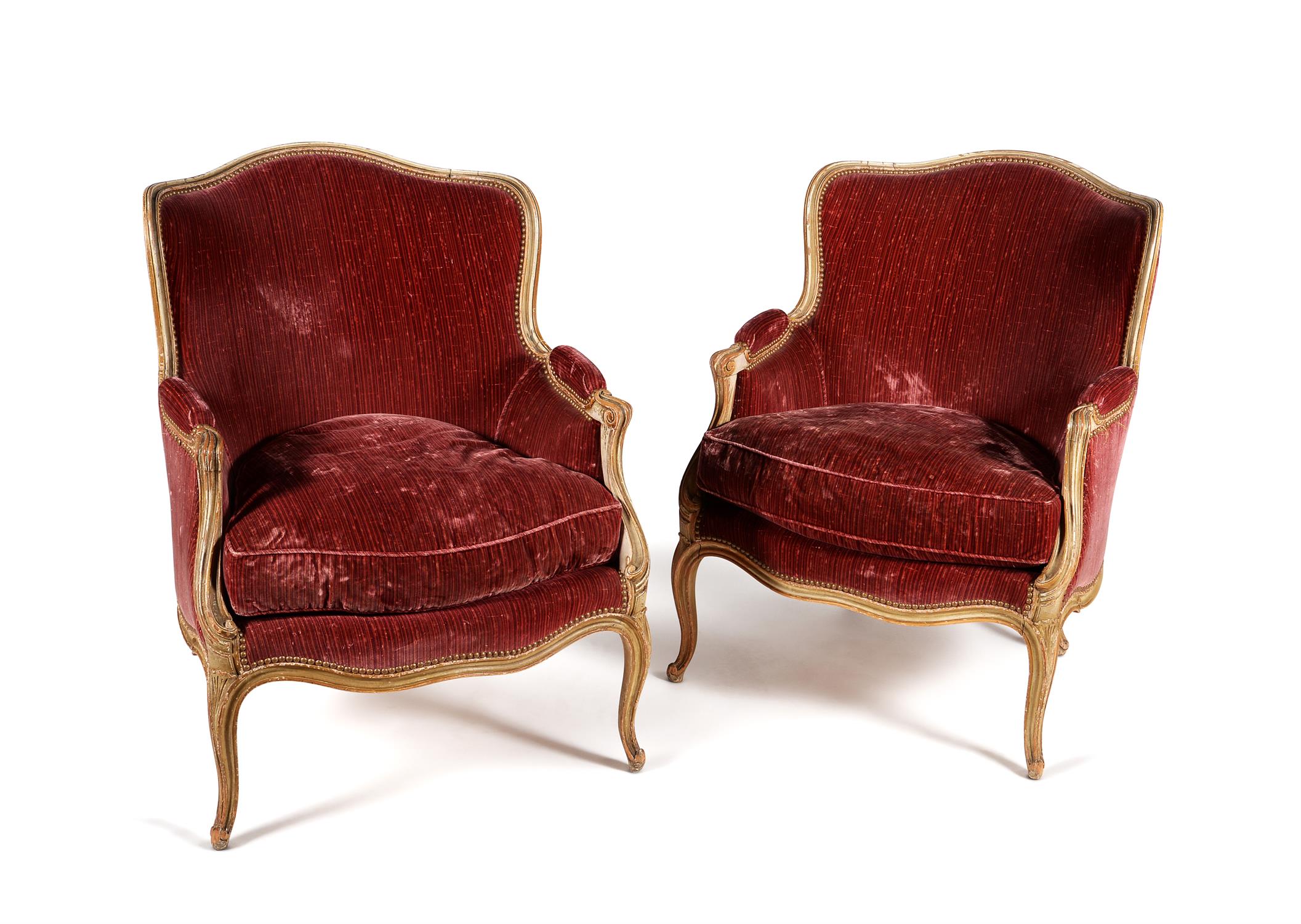 A pair of carved beech and painted tub shaped armchairs