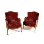 A pair of carved beech and painted tub shaped armchairs