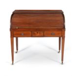 A George III mahogany and crossbanded roll top desk
