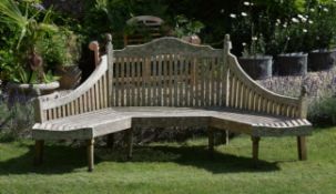 A large wooden garden bench in Arts an Crafts style