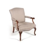 A carved beech and upholstered armchair