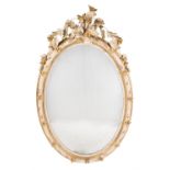 A Victorian cream painted, parcel gilt wood and composition oval mirror