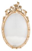 A Victorian cream painted, parcel gilt wood and composition oval mirror