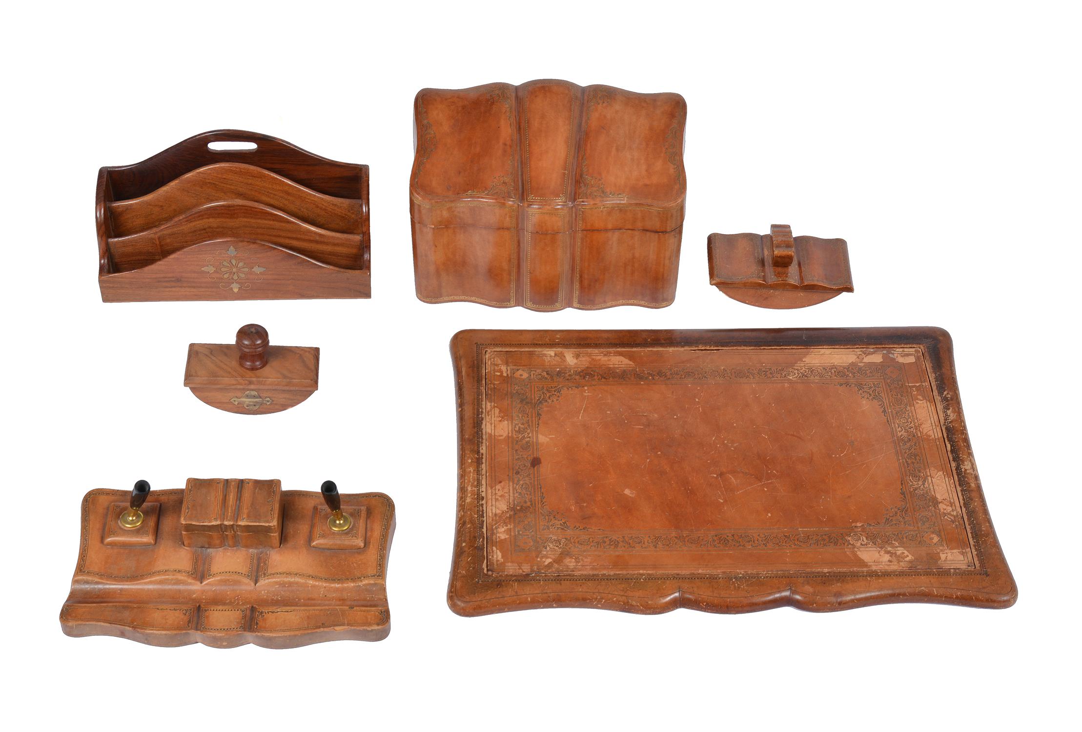 A group of leather clad desk items comprising; a Florentine brown leather envelope casket