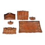 A group of leather clad desk items comprising; a Florentine brown leather envelope casket