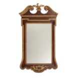 A mahogany and parcel gilt wood wall mirror