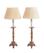 A pair of turned walnut candlesticks