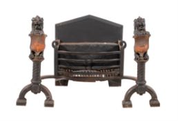 A Victorian wrought and cast iron and copper mounted fire grate