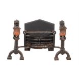 A Victorian wrought and cast iron and copper mounted fire grate