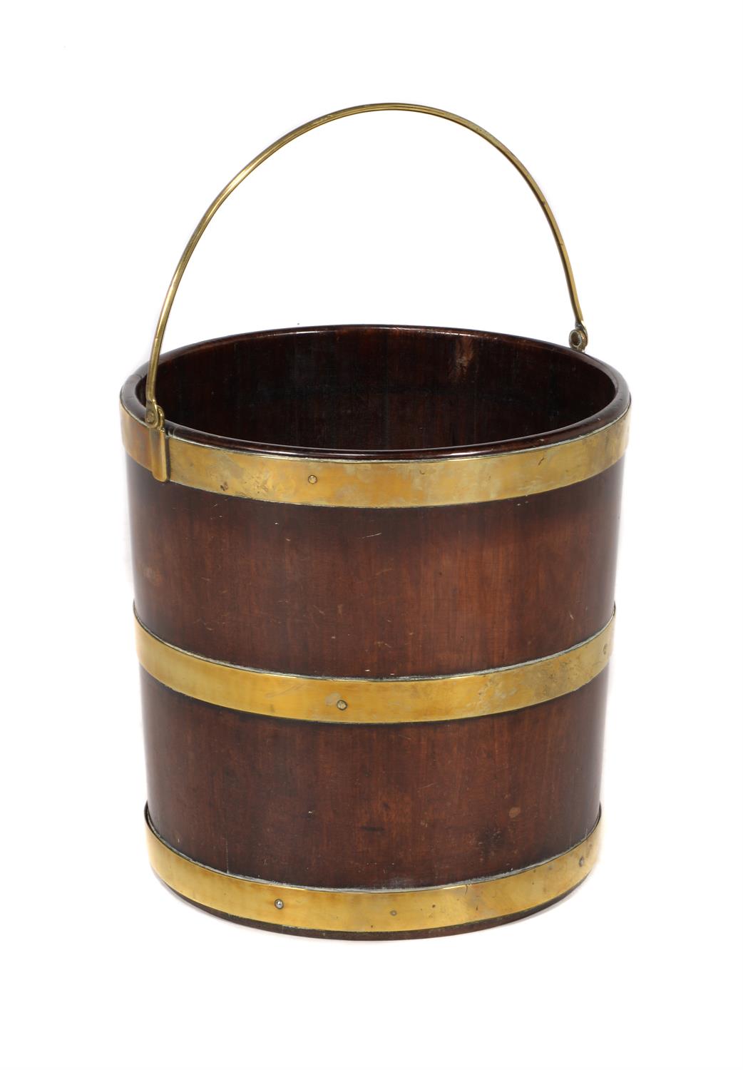 A George III circular mahogany and brass bound bucket