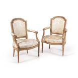 A pair of grey painted and upholstered armchairs in Louis XVI style