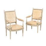 A pair of cream painted armchairs