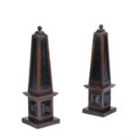 A pair of oak and ebonised obelisks