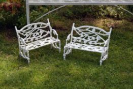 A pair of miniature cast iron garden benches in the manner of Coalbrookdale