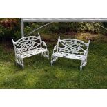 A pair of miniature cast iron garden benches in the manner of Coalbrookdale