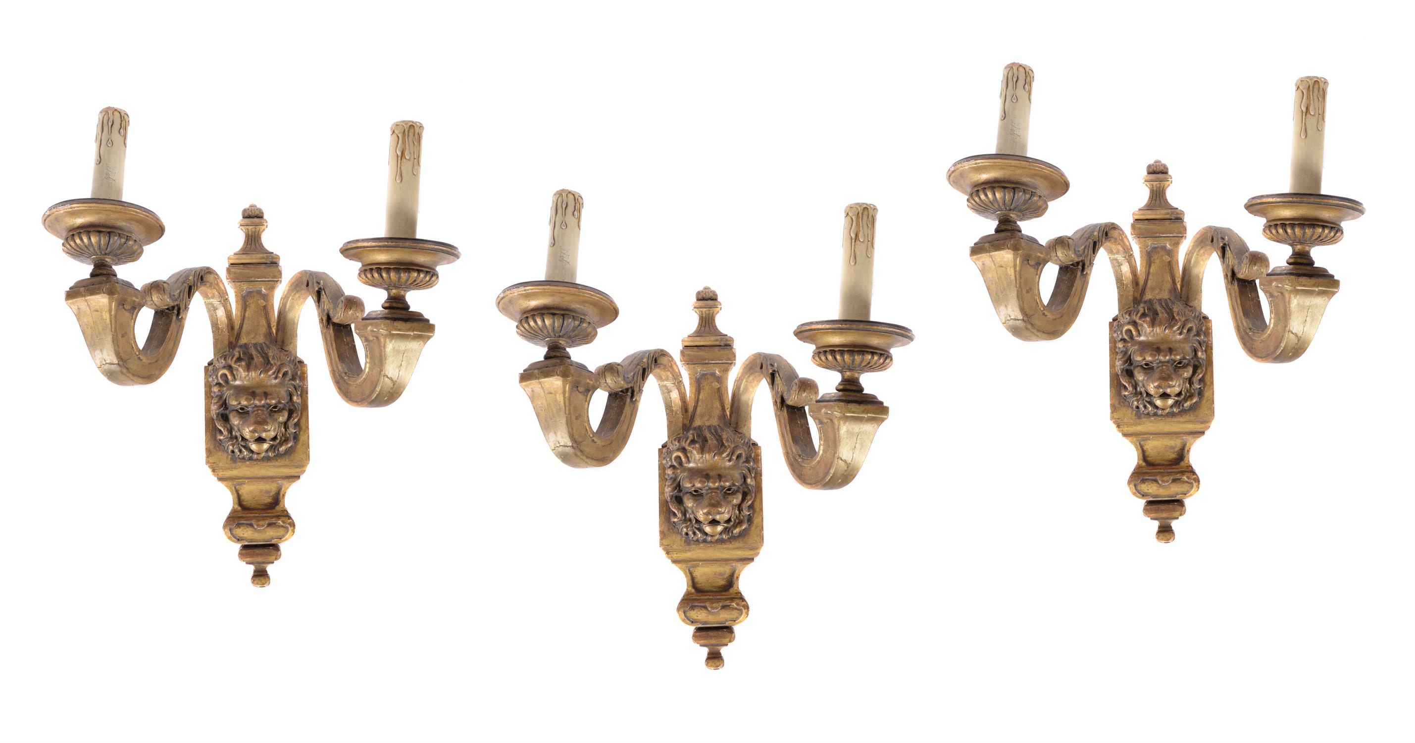 A set of three giltwood and gesso twin branch wall lights in Regence style