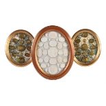 A pair of giltwood framed arrangements of brass intaglio casts after the Antique