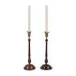 A pair of George III turned mahogany and brass mounted candlesticks