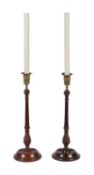 A pair of George III turned mahogany and brass mounted candlesticks