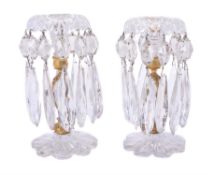 A pair of cut and moulded clear glass and gilt metal mounted lustre candlesticks