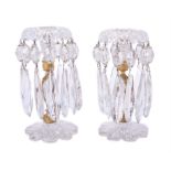 A pair of cut and moulded clear glass and gilt metal mounted lustre candlesticks