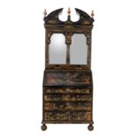 A black lacquered and gilt Chinoiserie decorated bureau bookcase