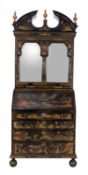 A black lacquered and gilt Chinoiserie decorated bureau bookcase