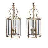 A pair of brass and glazed hexagonal hall lanterns