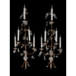 A pair of large brass and clear glass five light wall appliques in Louis XV style