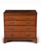 A George III mahogany and satinwood crossbanded chest of drawers