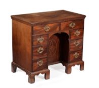 A George III mahogany and inlaid kneehole desk or dressing table