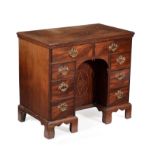 A George III mahogany and inlaid kneehole desk or dressing table