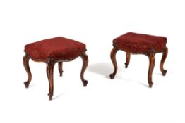 A pair of Victorian walnut and upholstered stools